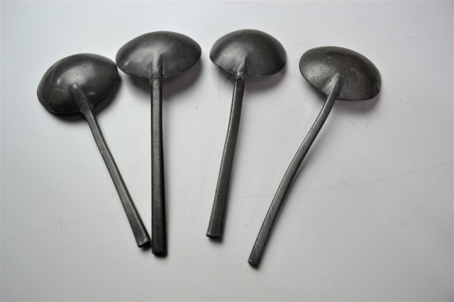 18th century spoon rack with pewter spoons.