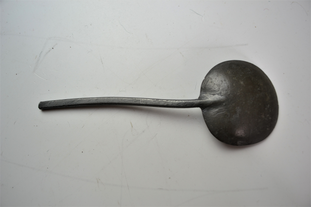 18th century spoon rack with pewter spoons.