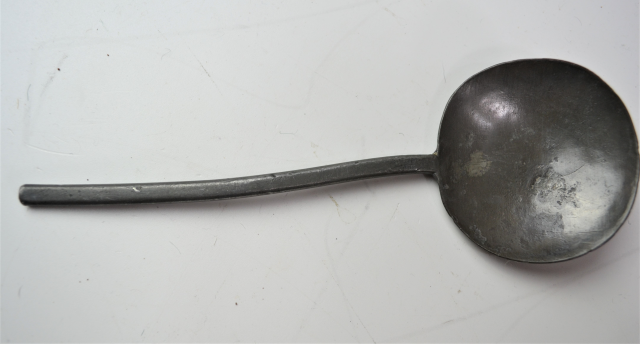 18th century spoon rack with pewter spoons.
