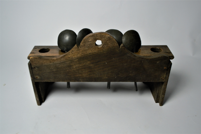 18th century spoon rack with pewter spoons.