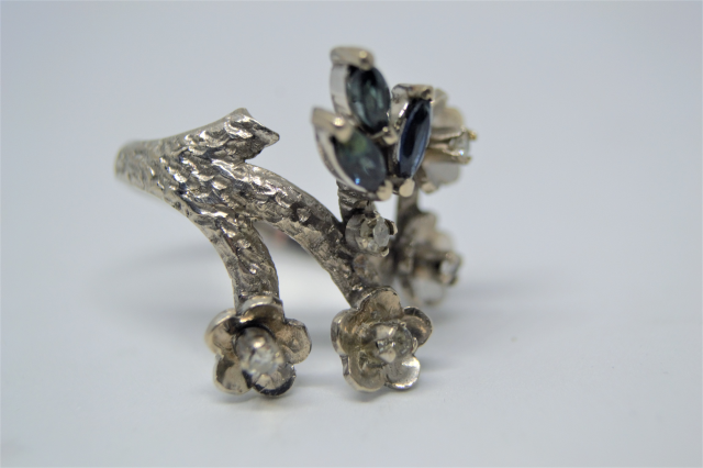 A White Metal With Sapphire And Diamond Abstract Ring.