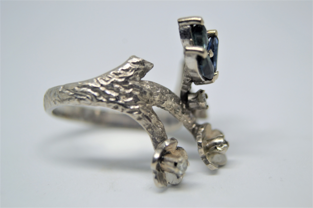 A White Metal With Sapphire And Diamond Abstract Ring.