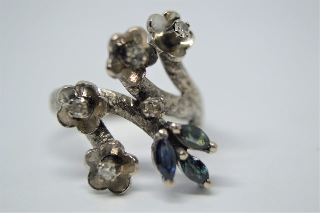 A White Metal With Sapphire And Diamond Abstract Ring.