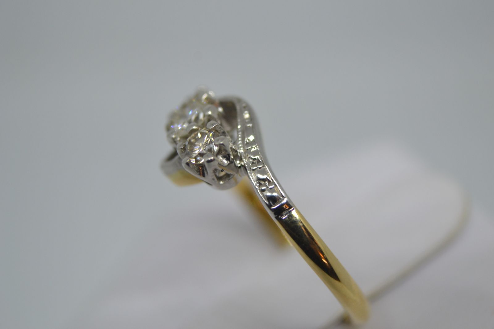 A Three Stone Diamond Cross Over Ring