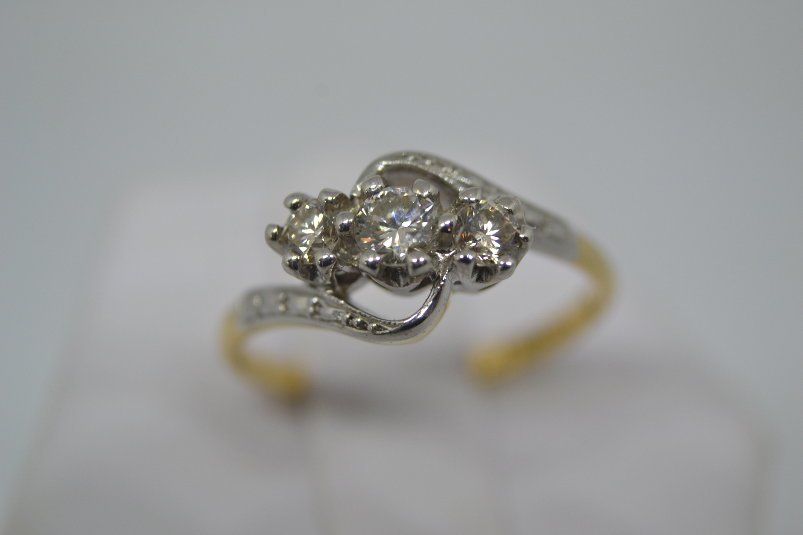 A Three Stone Diamond Cross Over Ring