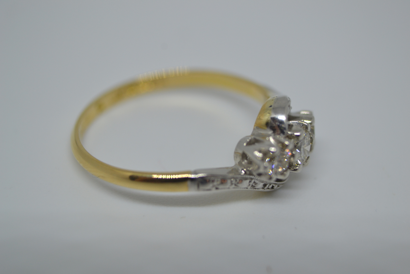 A Three Stone Diamond Cross Over Ring