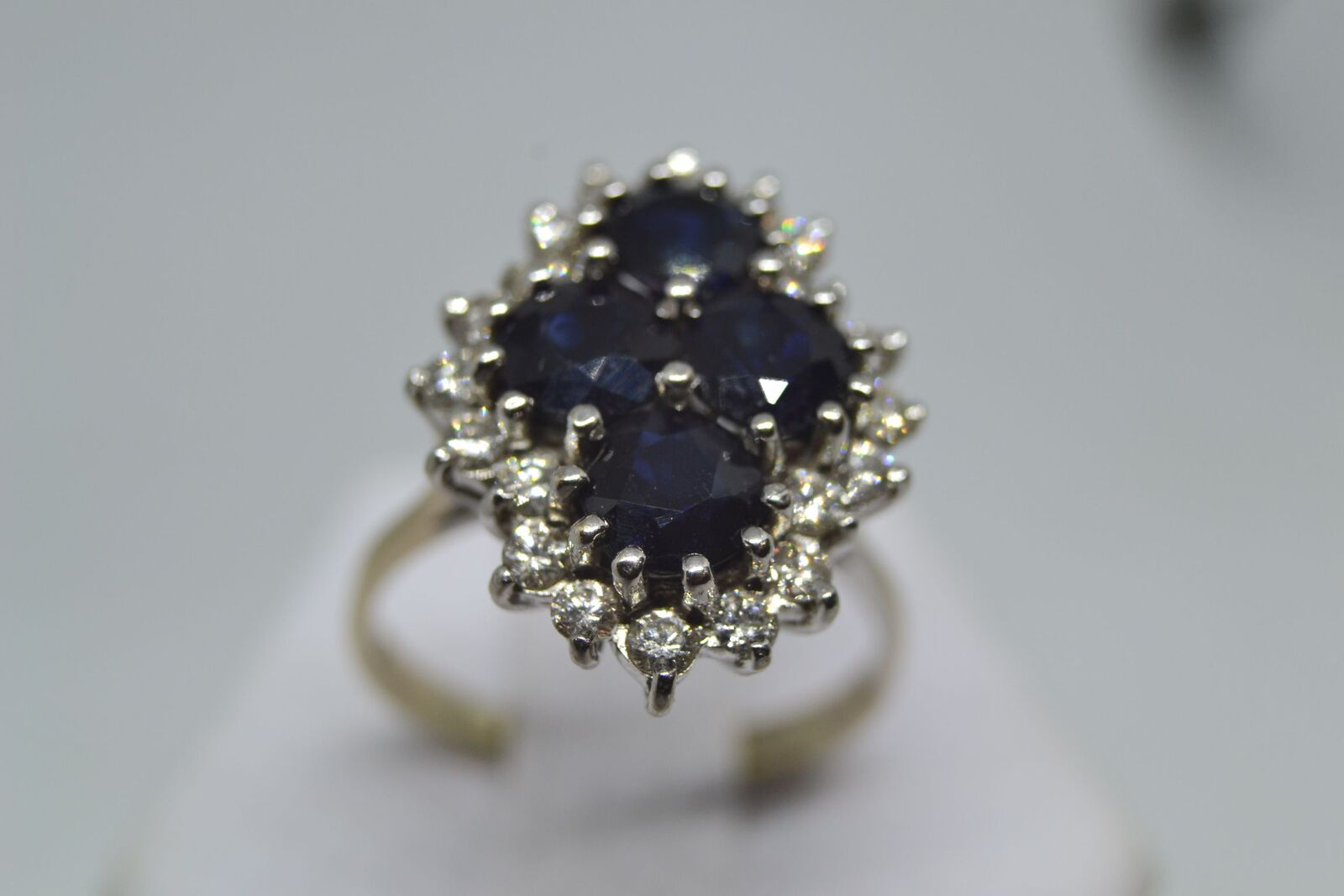An 18ct white gold sapphire and diamond cluster ring