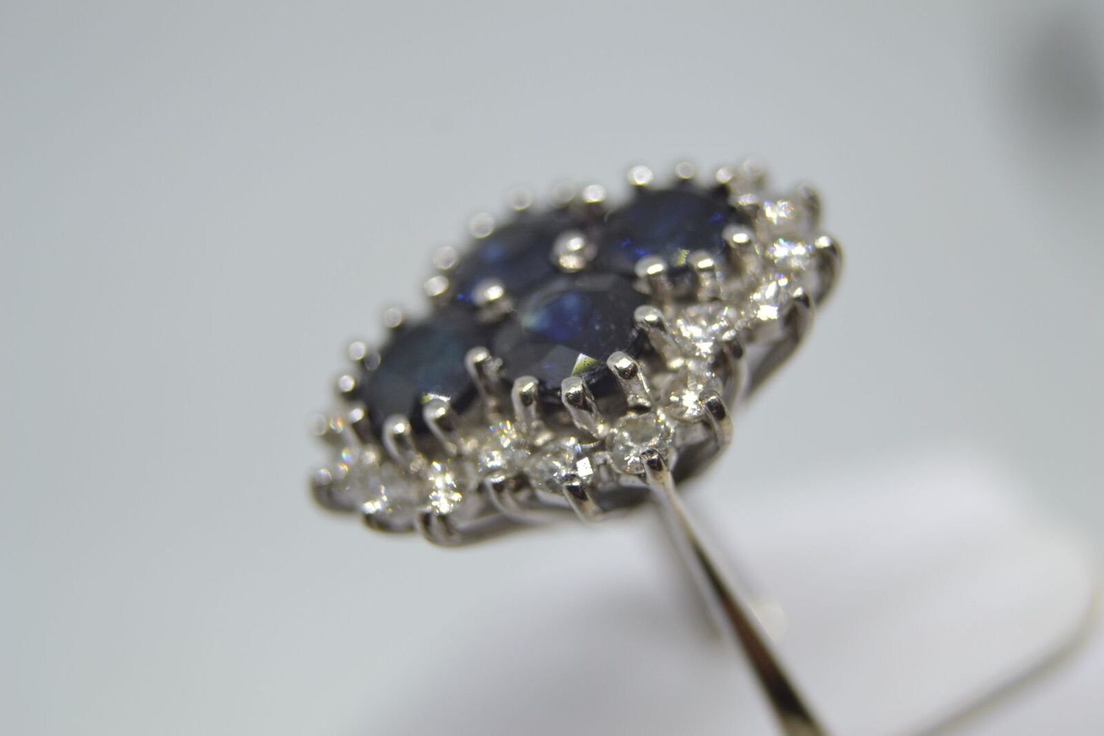 An 18ct white gold sapphire and diamond cluster ring